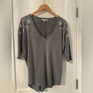 Grey 3/4 sleeve top with silver detailing on shoulders